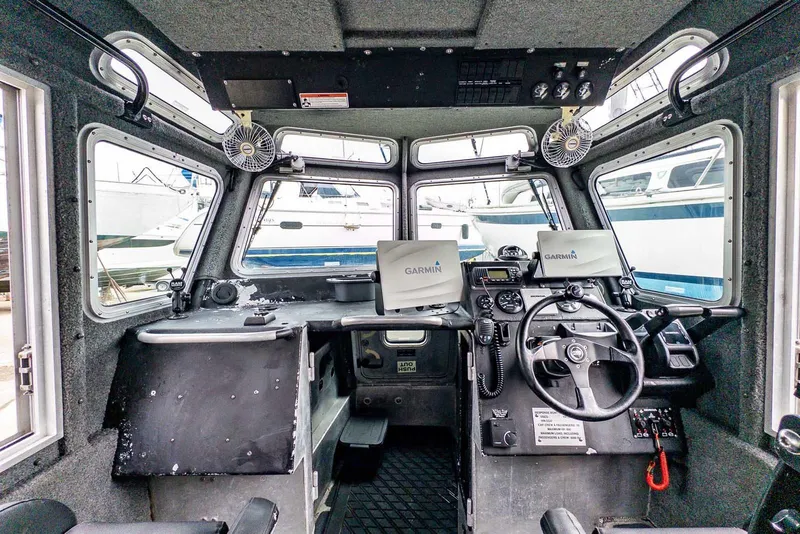 Slide: The Image of 2004 SAFE Boats Defender interior with Garmin navigation systems and steering controls. - 15