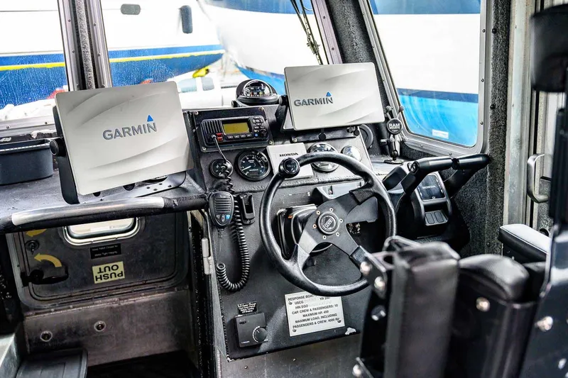 Slide: The Image of Cockpit of 2004 SAFE Boats Defender with Garmin navigation systems. - 16