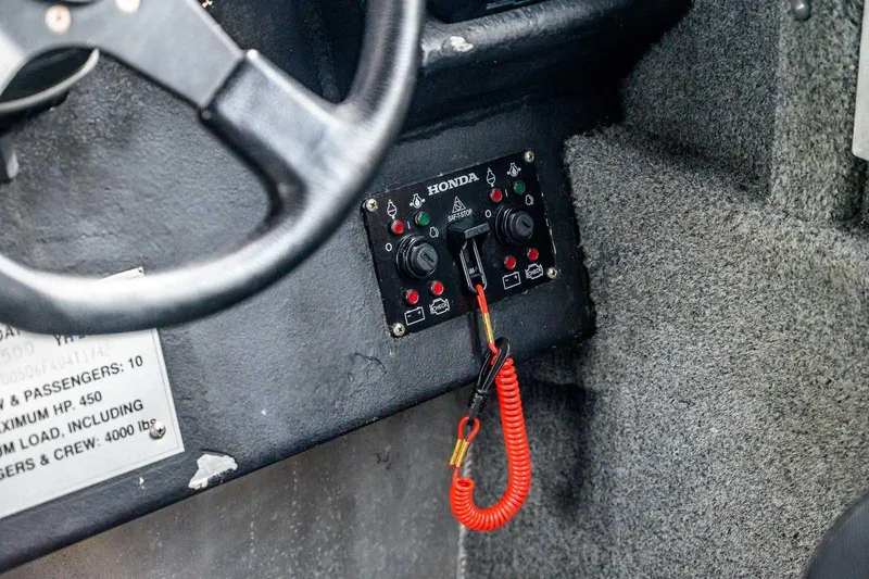 Slide: The Image of Control panel of a 2004 SAFE Boats Defender with Honda safety stop switch. - 17