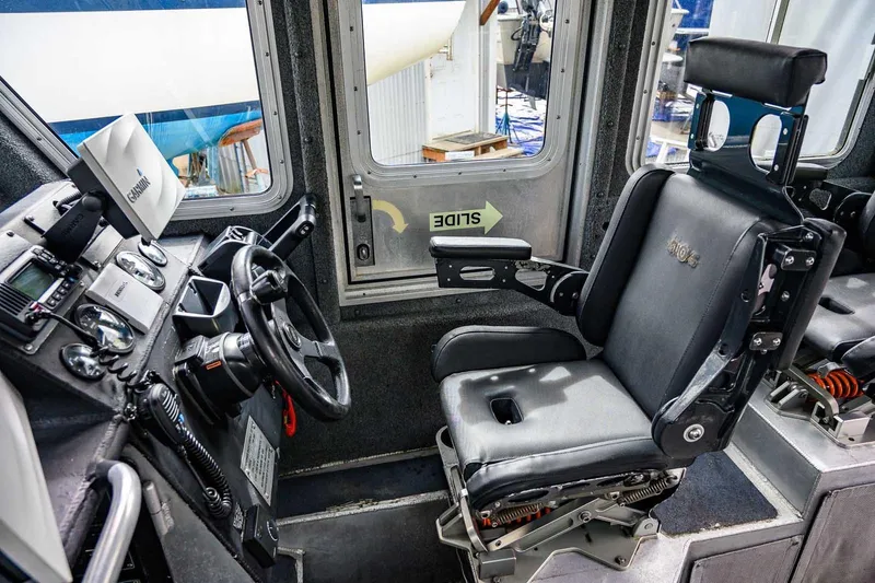 Slide: The Image of 2004 SAFE Boats Defender interior with Garmin navigation systems and steering controls. - 18