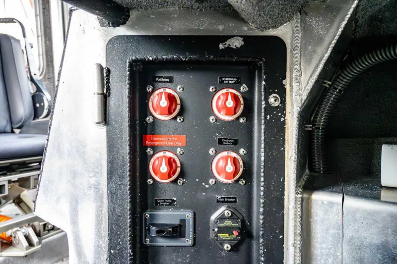 Slide: The Image of Interior of a 2004 SAFE Boats Defender, featuring a steering wheel and control panel. - 21