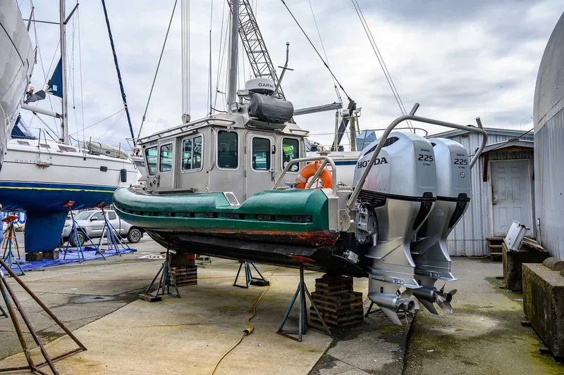 Slide: The Image of 2004 SAFE Boats Defender with twin Honda 225 engines in a boatyard. - 3