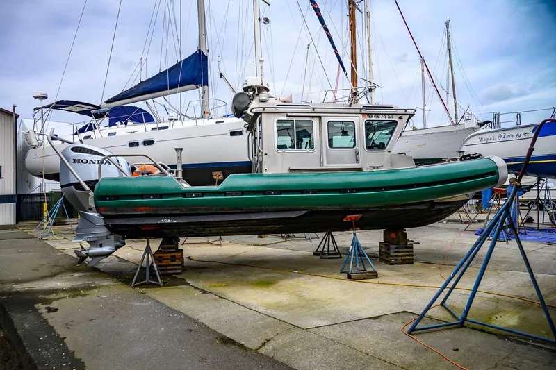 Slide: The Image of 2004 SAFE Boats Defender on dry dock, surrounded by sailboats, in a marina setting. - 5