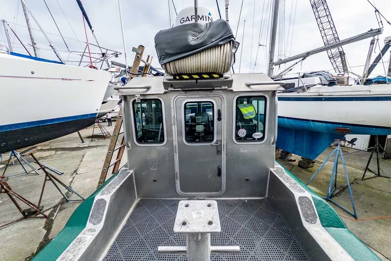 Slide: The Image of 2004 SAFE Boats Defender in a boatyard, surrounded by sailboats and equipment. - 7