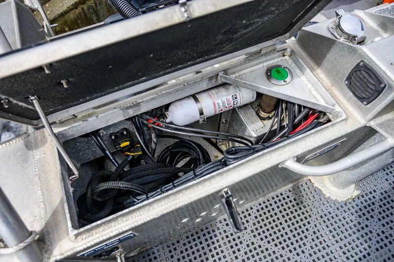 Slide: The Image of Open compartment of a 2004 SAFE Boats Defender, showing wiring and equipment. - 9