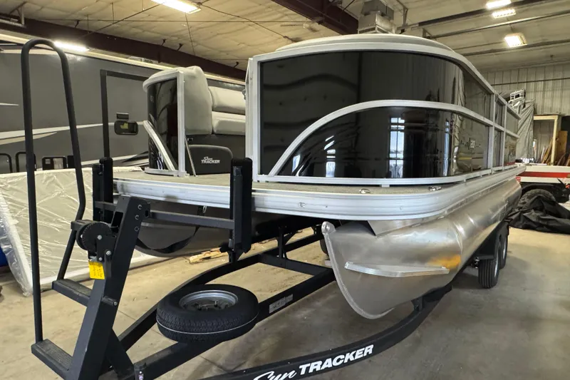 The Image of 2026 Sun Tracker Party Barge 20 DLX pontoon boat in indoor storage. - 1