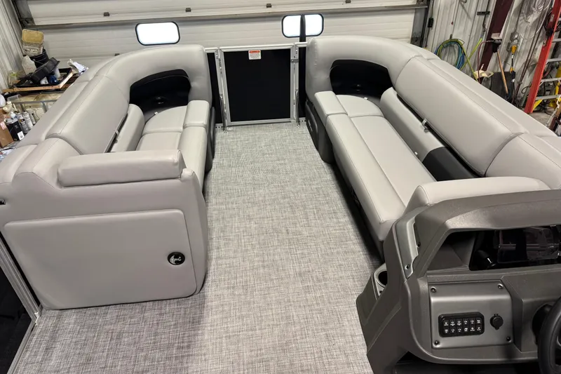 Slide: The Image of 2026 Sun Tracker Party Barge 20 DLX interior with gray seating and modern dashboard. - 7