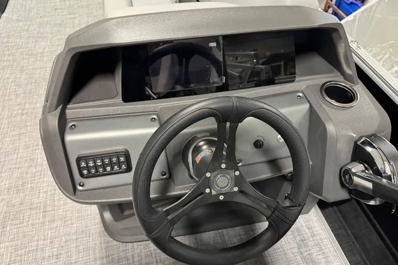 Slide: The Image of 2026 Sun Tracker Party Barge 20 DLX dashboard with steering wheel and control panel. - 8