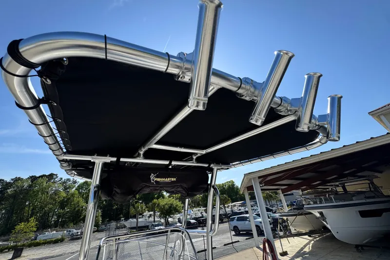 Slide: The Image of T-top on 2007 Edgewater 188CC boat with rod holders, under clear blue sky. - 10