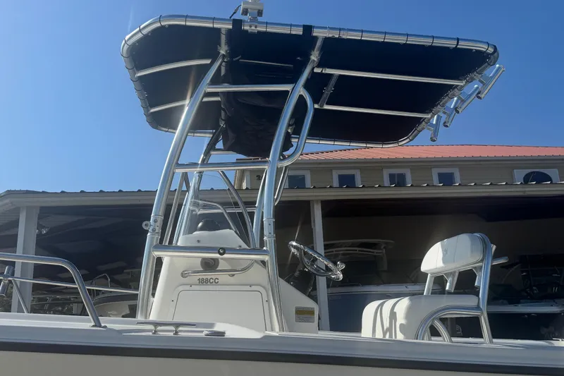 Slide: The Image of 2007 Edgewater 188CC boat with T-top and steering console under clear blue sky. - 3