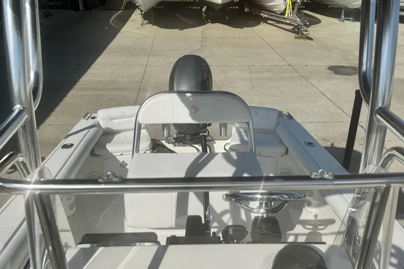 Slide: The Image of 2007 Edgewater 188CC boat interior with steering wheel and seating, parked in a marina. - 6
