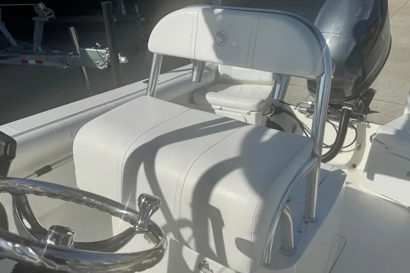 Slide: The Image of 2007 Edgewater 188CC boat interior with white seating and steering wheel. - 7