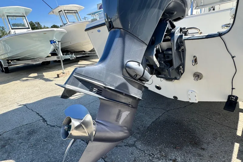 Slide: The Image of Outboard motor on a 2007 Edgewater 188CC boat, with other boats in the background. - 9