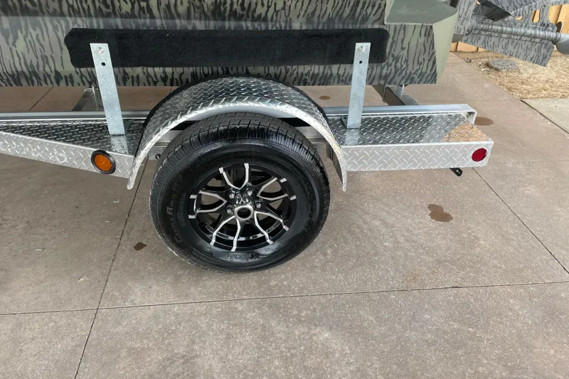 Slide: The Image of Trailer wheel of 2026 Reaper Boats 753 Timber Reaper on diamond plate fender. - 7