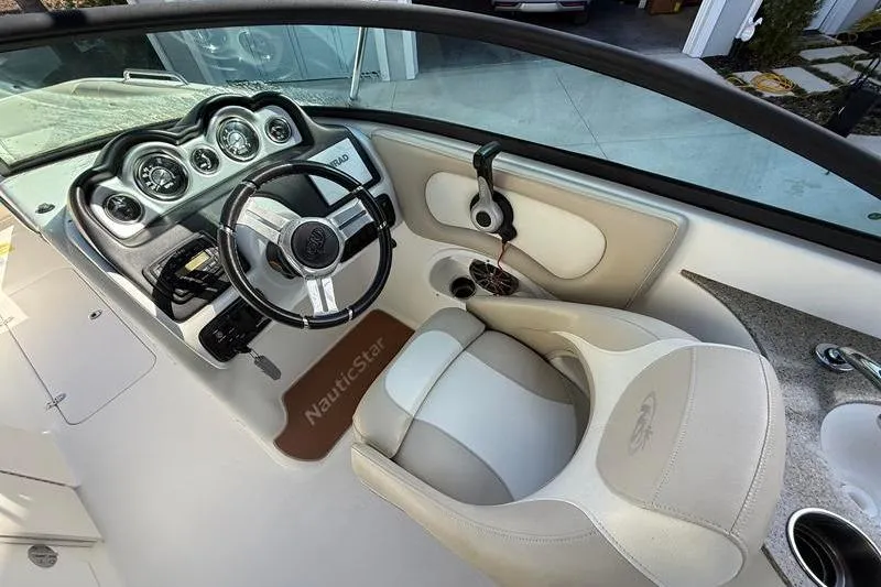 Slide: The Image of Interior view of 2017 NauticStar 243DC Sport Deck boat cockpit and steering wheel. - 15
