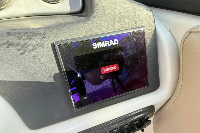 Slide: The Image of Simrad navigation system on 2017 NauticStar 243DC Sport Deck boat dashboard. - 18