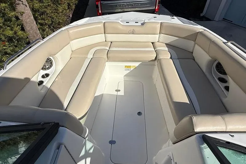 Slide: The Image of 2017 NauticStar 243DC Sport Deck boat interior with beige seating and spacious layout. - 21