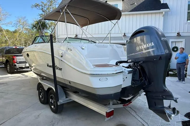 Slide: The Image of 2017 NauticStar 243DC Sport Deck boat with Yamaha 200 engine on trailer. - 3