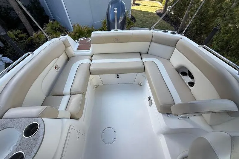Slide: The Image of 2017 NauticStar 243DC Sport Deck boat interior with beige seating and cup holders. - 8