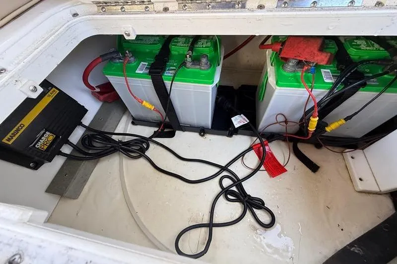 Slide: The Image of Battery compartment of a 2017 NauticStar 243DC Sport Deck with charger and wiring. - 9