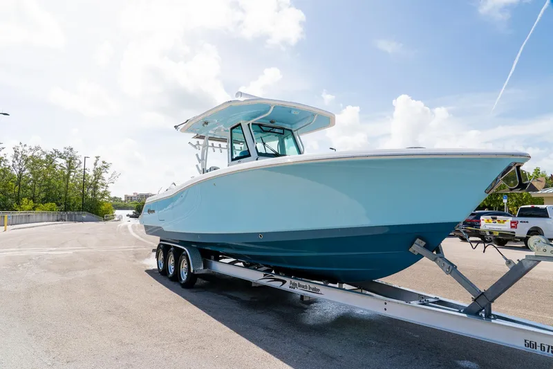 Slide: The Image of 2024 Crevalle 33 CSF boat on trailer under clear sky. - 12