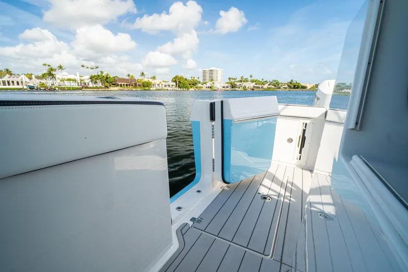 Slide: The Image of 2024 Crevalle 33 CSF boat deck with scenic waterfront view. - 19