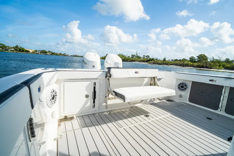Slide: The Image of 2024 Crevalle 33 CSF boat deck with seating, on a serene waterway. - 20