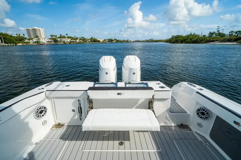 Slide: The Image of 2024 Crevalle 33 CSF boat with dual engines on a serene waterway. - 21
