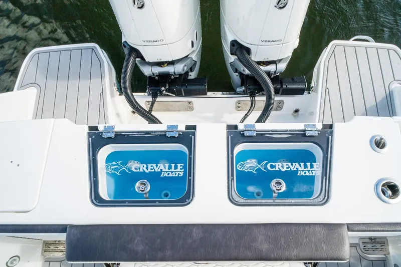 Slide: The Image of 2024 Crevalle 33 CSF boat with dual outboard engines and branded livewell. - 28