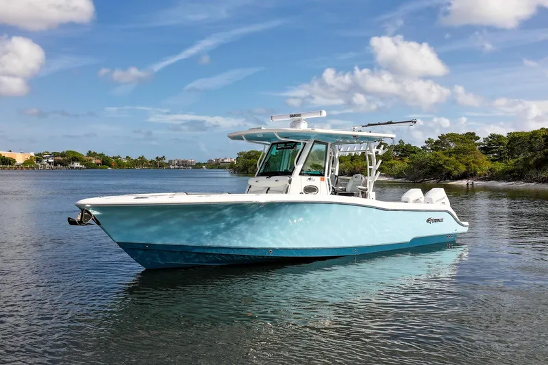 Slide: The Image of 2024 Crevalle 33 CSF boat on calm water under a blue sky. - 3