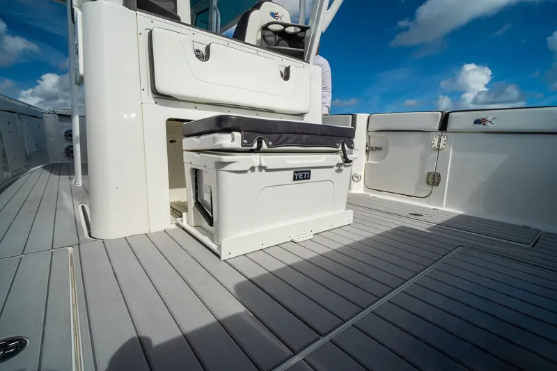 Slide: The Image of 2024 Crevalle 33 CSF boat deck with Yeti cooler and seating under blue sky. - 34