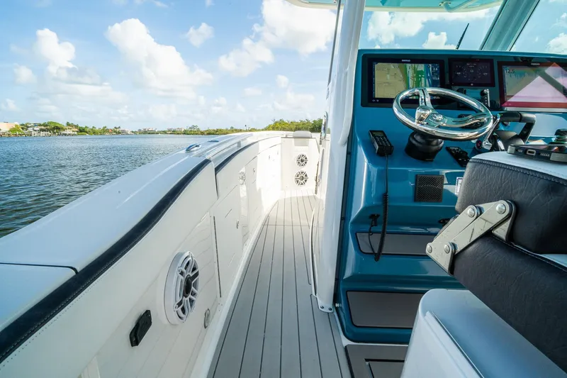 Slide: The Image of 2024 Crevalle 33 CSF boat interior with modern helm and scenic water view. - 36