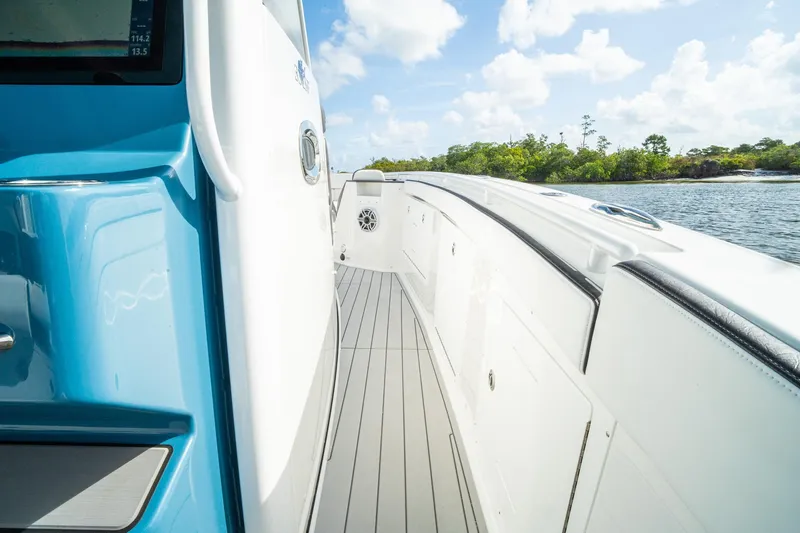 Slide: The Image of 2024 Crevalle 33 CSF boat deck with sleek design, near scenic waterway. - 37