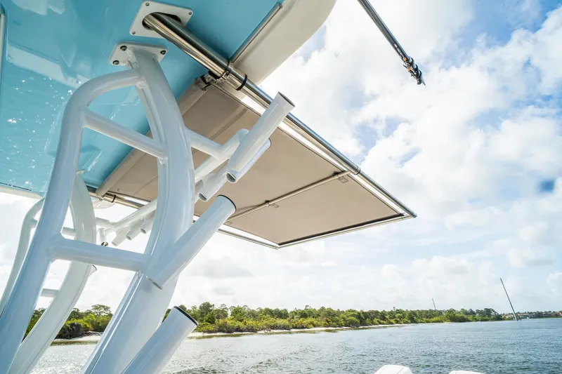 Slide: The Image of 2024 Crevalle 33 CSF boat with canopy, scenic water and sky background. - 38