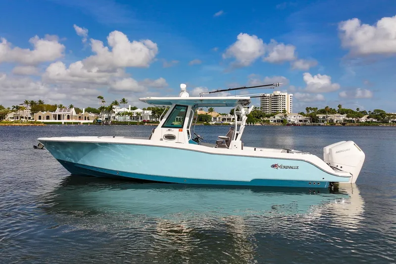 Slide: The Image of 2024 Crevalle 33 CSF boat on calm water, clear sky background. - 4