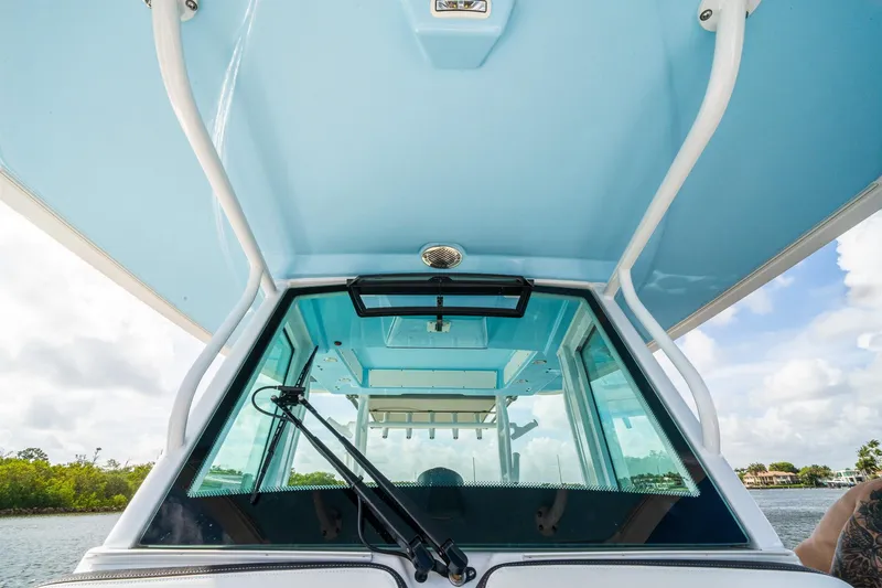 Slide: The Image of 2024 Crevalle 33 CSF boat windshield and canopy, showcasing sleek design and clear skies. - 41