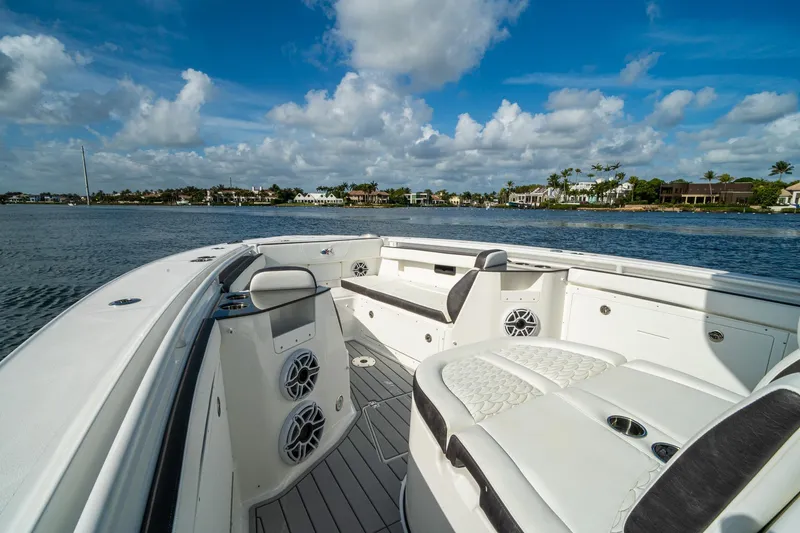 Slide: The Image of 2024 Crevalle 33 CSF boat interior with seating, speakers, and scenic waterfront view. - 42