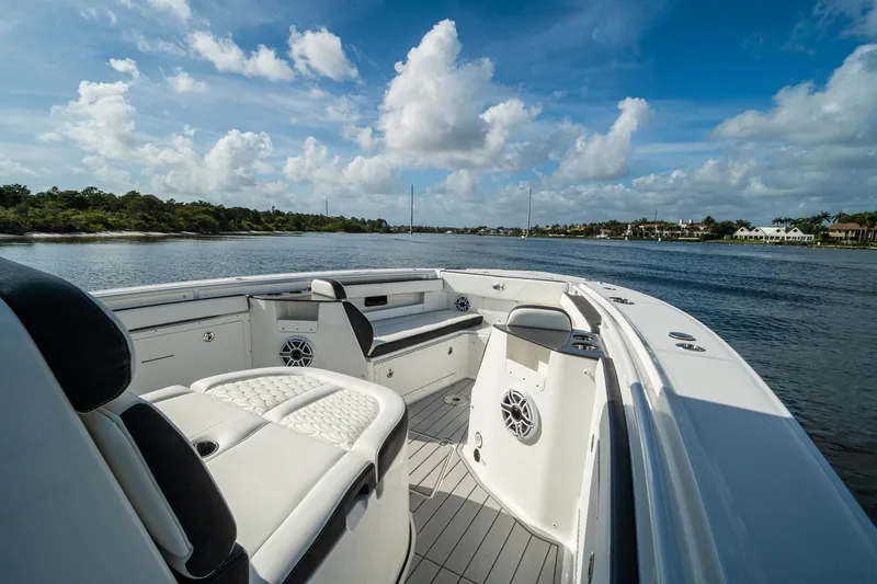 Slide: The Image of 2024 Crevalle 33 CSF boat interior with luxurious seating on a scenic waterway. - 43