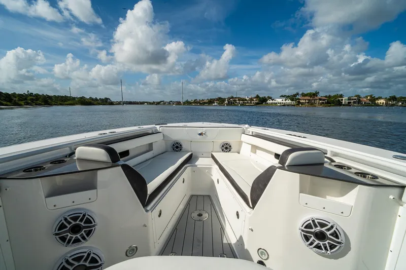 Slide: The Image of 2024 Crevalle 33 CSF boat interior with seating, speakers, and scenic water view. - 44