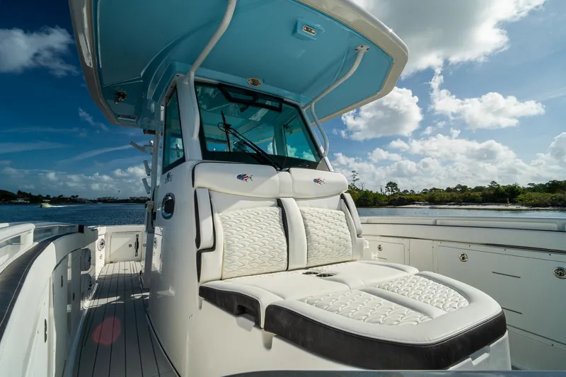 Slide: The Image of 2024 Crevalle 33 CSF boat with luxurious seating, under a clear blue sky. - 48