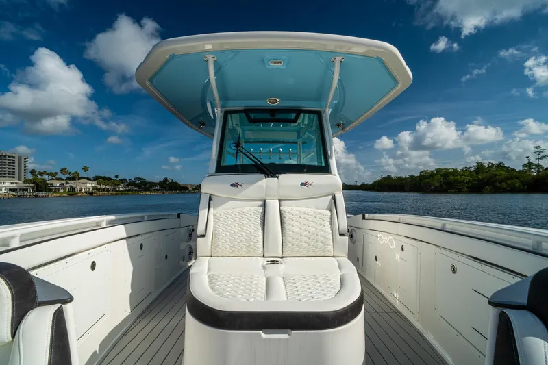 Slide: The Image of 2024 Crevalle 33 CSF boat interior with seating, under a clear blue sky. - 49