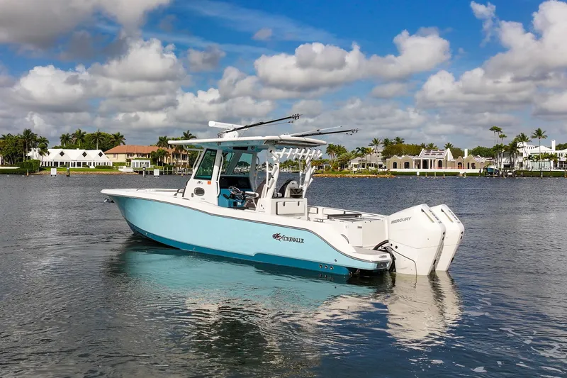 Slide: The Image of 2024 Crevalle 33 CSF boat on calm water, with scenic waterfront background. - 5