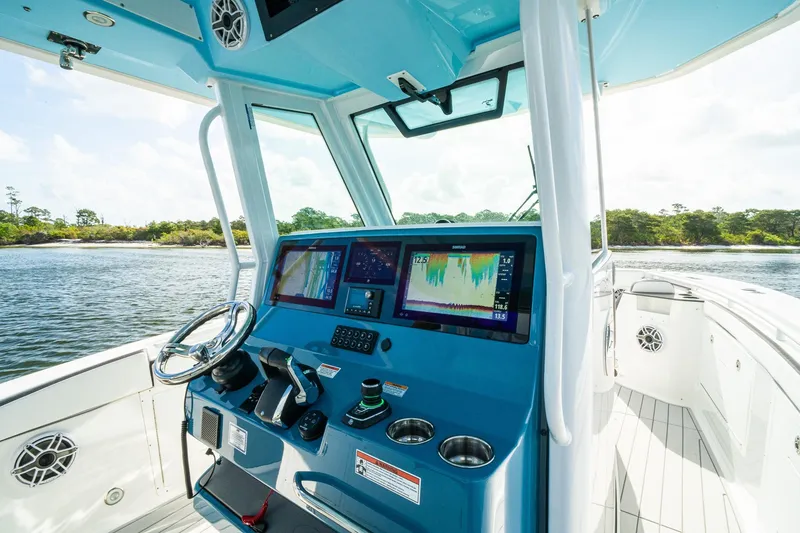 Slide: The Image of 2024 Crevalle 33 CSF boat cockpit with advanced navigation displays and controls. - 50