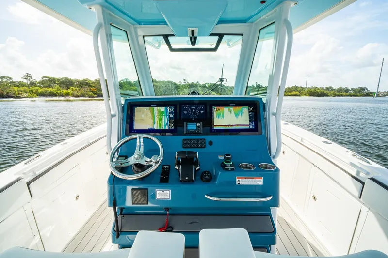 Slide: The Image of 2024 Crevalle 33 CSF boat helm with advanced navigation displays and steering wheel. - 51