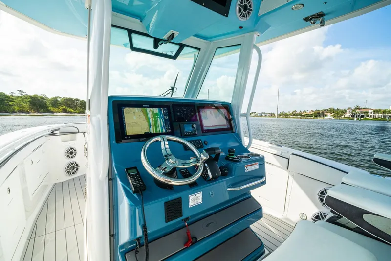 Slide: The Image of 2024 Crevalle 33 CSF boat cockpit with advanced navigation system and scenic water view. - 52
