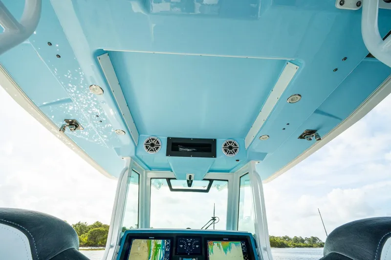 Slide: The Image of 2024 Crevalle 33 CSF boat interior with blue ceiling and navigation equipment. - 54