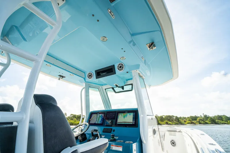 Slide: The Image of 2024 Crevalle 33 CSF boat interior with advanced navigation system and blue canopy. - 55