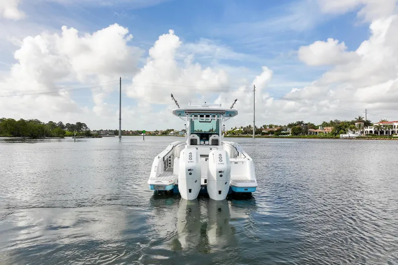 Slide: The Image of 2024 Crevalle 33 CSF boat on calm water under a partly cloudy sky. - 6