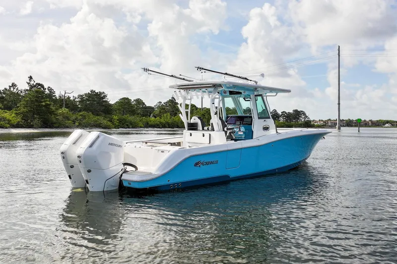 Slide: The Image of 2024 Crevalle 33 CSF boat on calm water, featuring twin Mercury engines. - 7