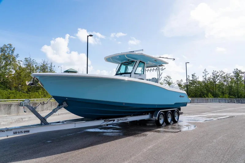 Slide: The Image of 2024 Crevalle 33 CSF boat on trailer, parked outdoors under clear sky. - 9